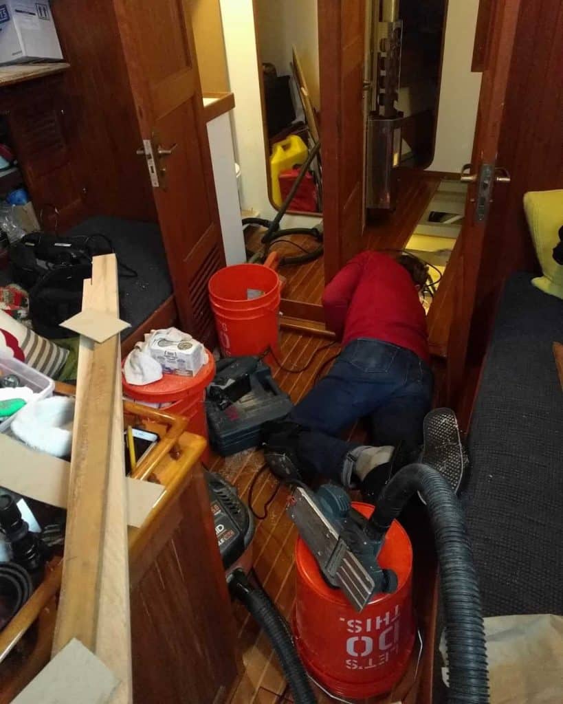 Tom working on our holding tank while living on a sailboat