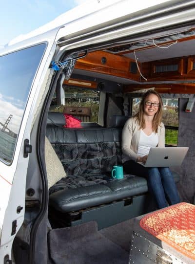 Kristin doing a van life job from her Chevy Astro Van