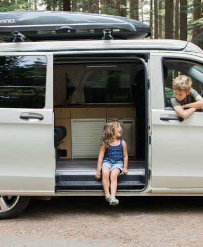 Peace Vans Pop-Up Camper with kids sitting in the van