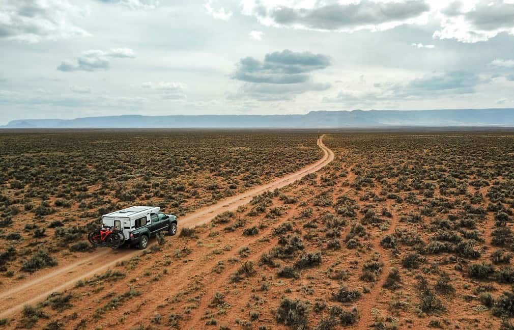 Fleet Pop Up Truck Camper driving down a desert road