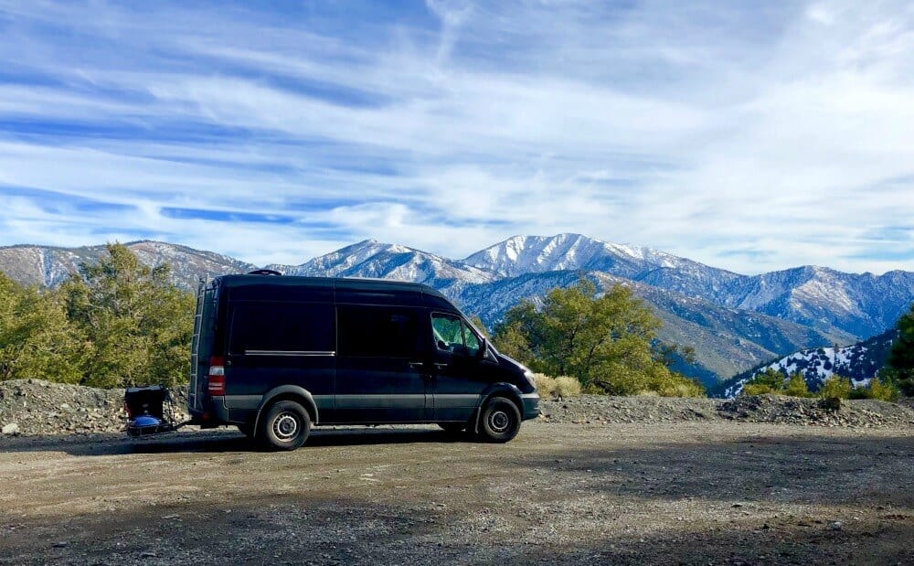 Mercedes Sprinter Camper on a road in front of mountains