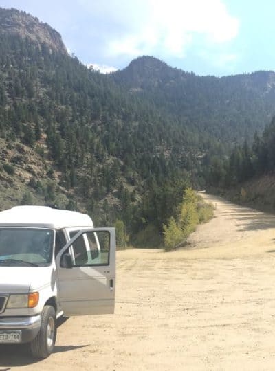 Ford Econoline DIY camper parked on a dirt road