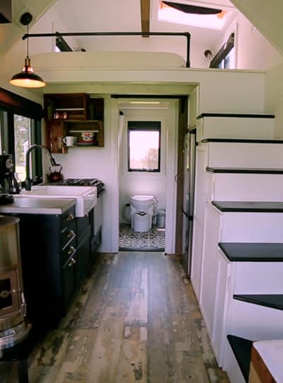 The inside of a tiny house with a tiny house wood burning stove