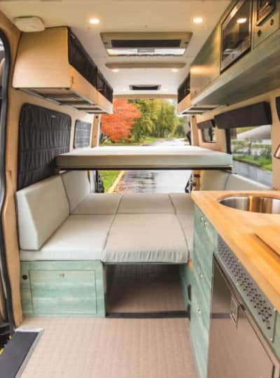A permanent elevated van bed is the bed choice of this conversion.