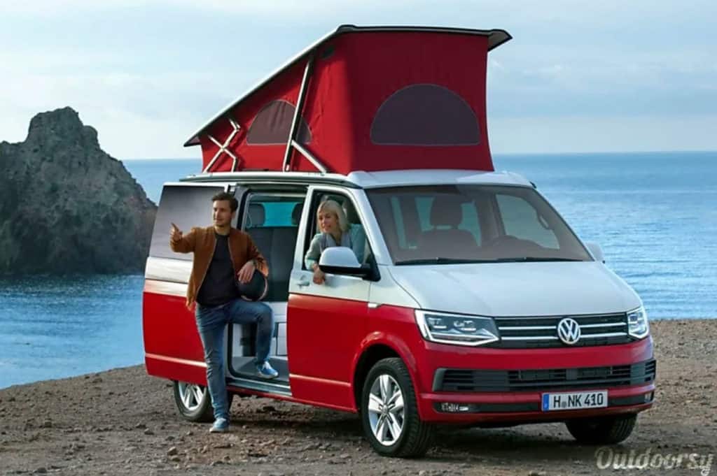 VW camper California campervan hire parked on a bluff above the sea with a ma and a woman