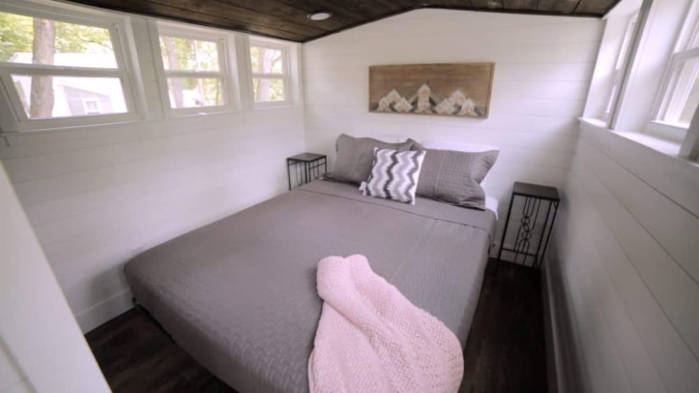 An interior bedroom shot of a tiny house on a tiny house trailer