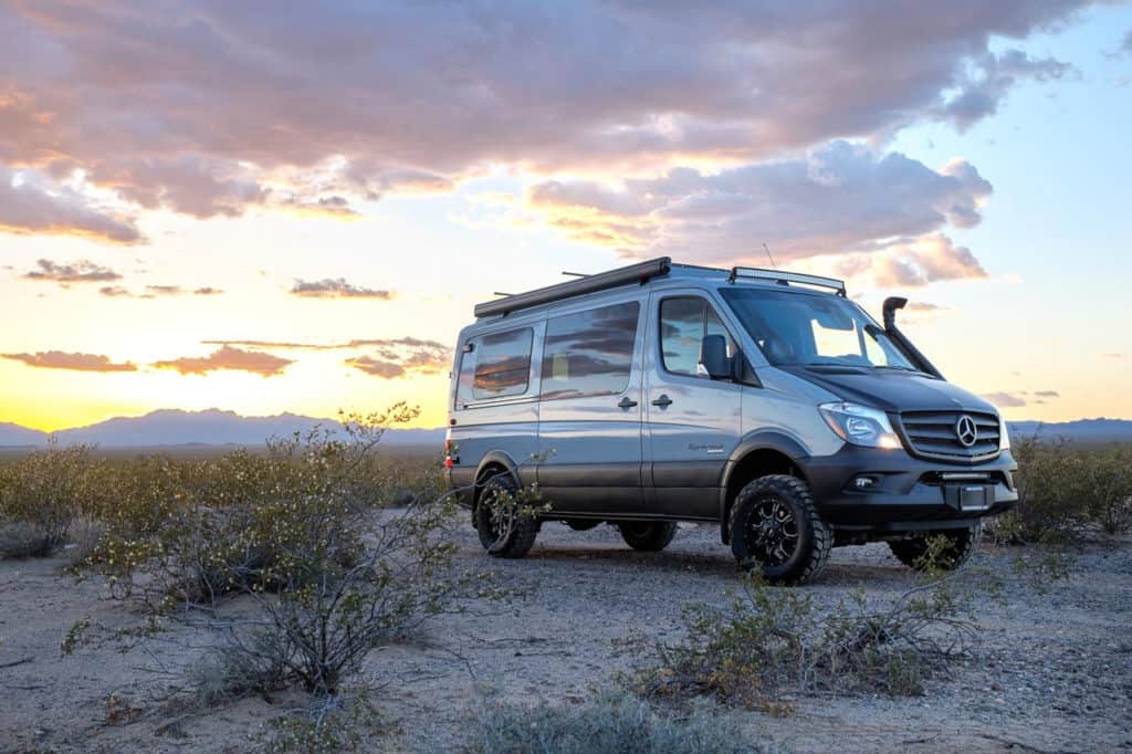 sportsmobile sprinter van for sale parked in the desert at sunset