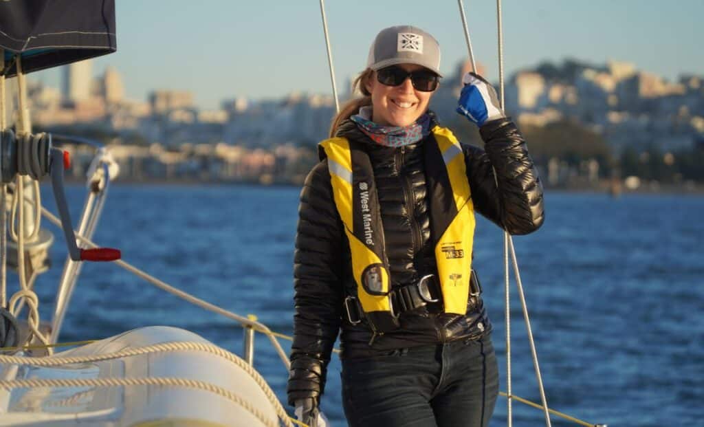 woman wearing a jacket and life jacket while sailing