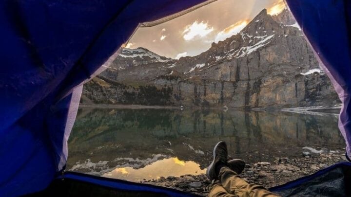 Tent overlooks mountain and lake