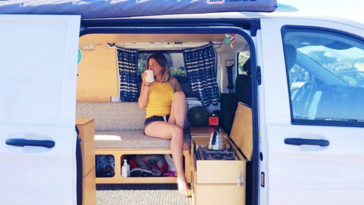woman sitting inside a Metris camper conversion