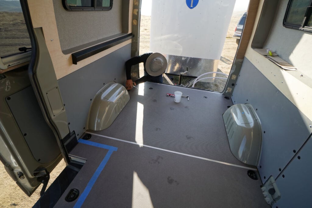 empty cargo van with body flares and bed support system