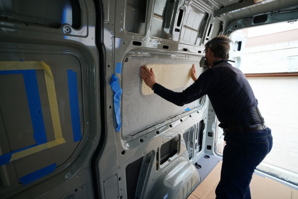 Man adding the interior finish kit to the Sprinter van flares on the inside