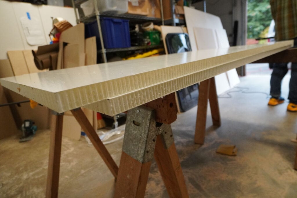 Two Sprinter van bed panels on saw horses in a garage