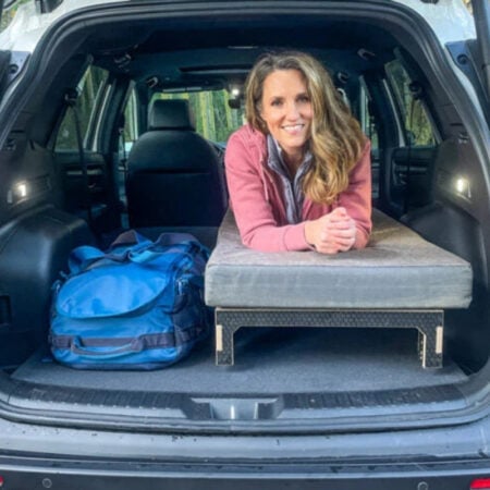 woman on camping bed. in hatchback car