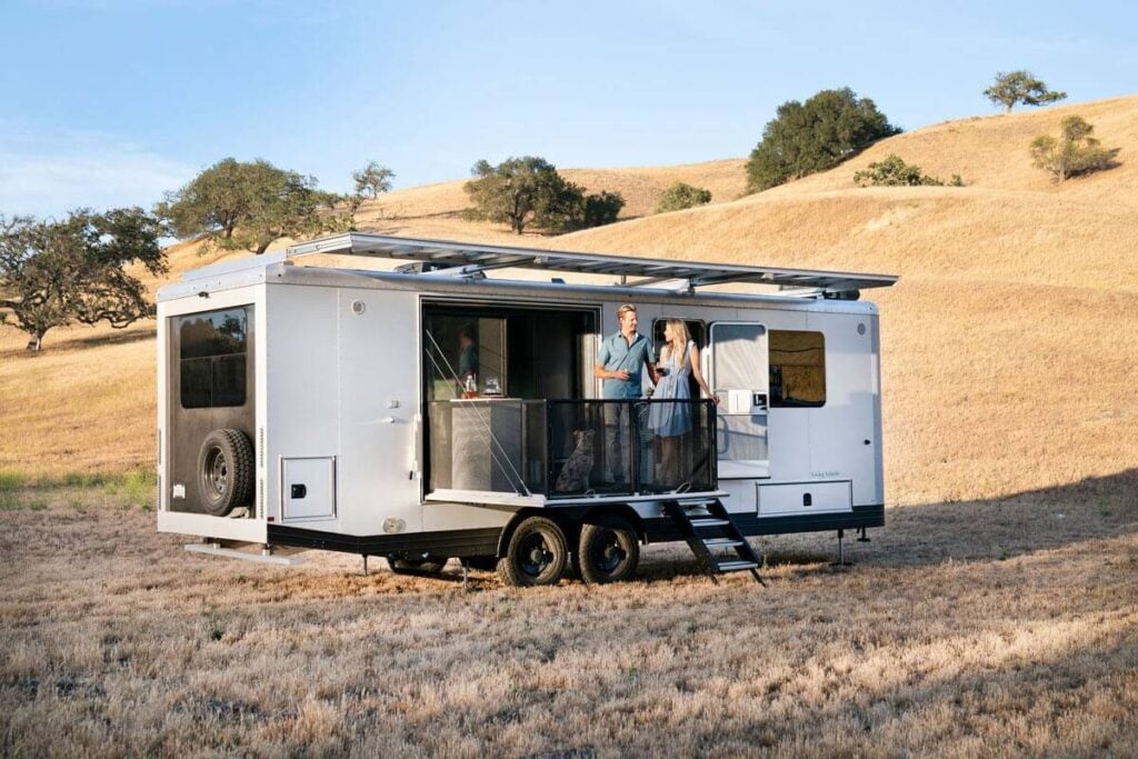 couple inside a travel trailer parked outdoors