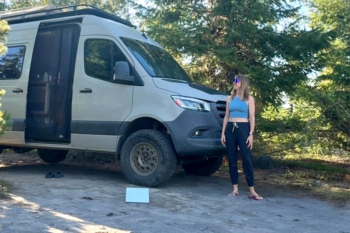 woman standing next to Sprinter van and Starlink Mini