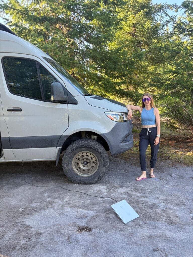 woman standing by Sprinter and starlink
