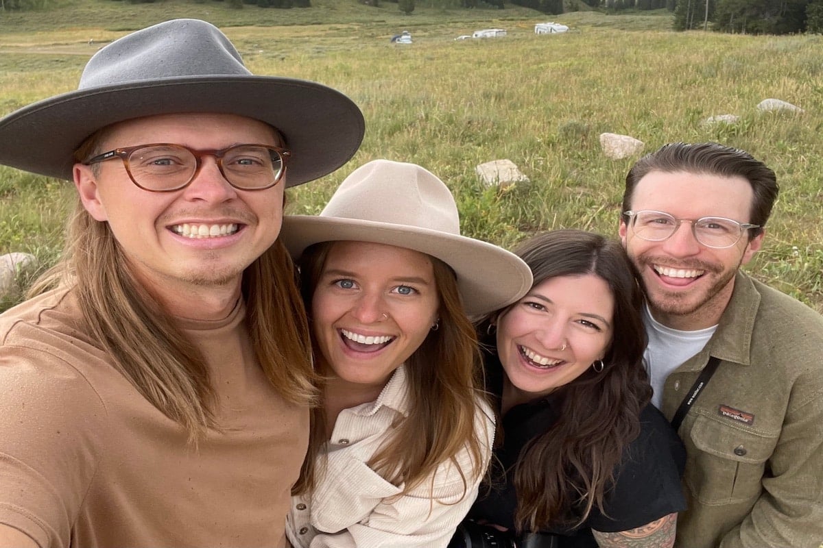 A photo of two men and two women smiling.