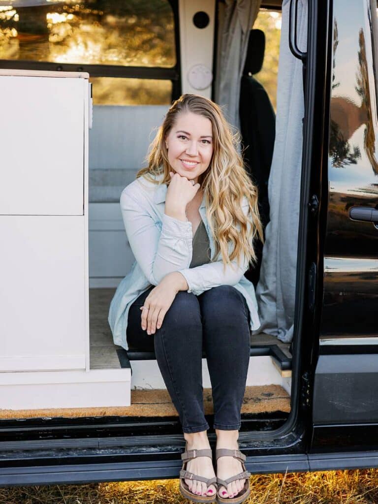 beautiful woman sitting in her campervan
