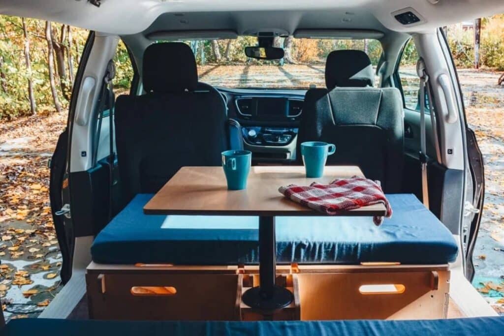 minivan camper showing its interior parked outdoors