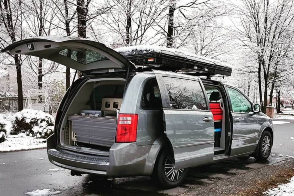 minivan camper parked on the road showing its freeway camper kit inside