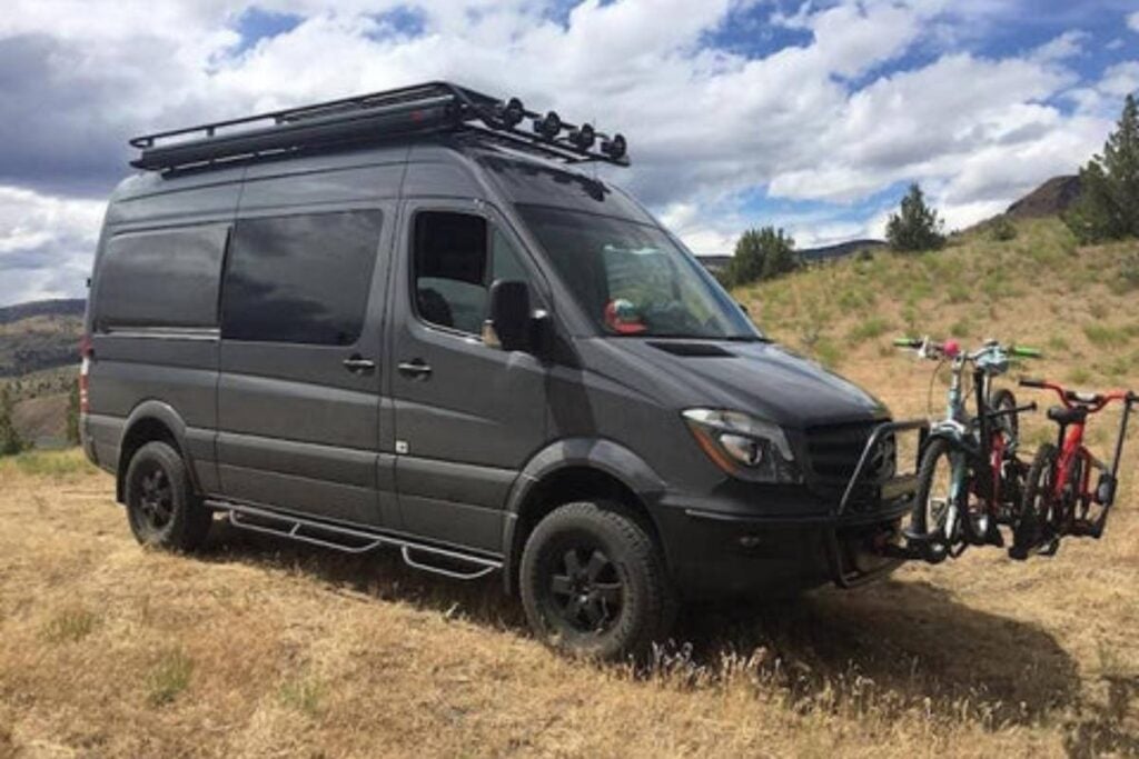 sprinter van with a roof rack parked outdoors