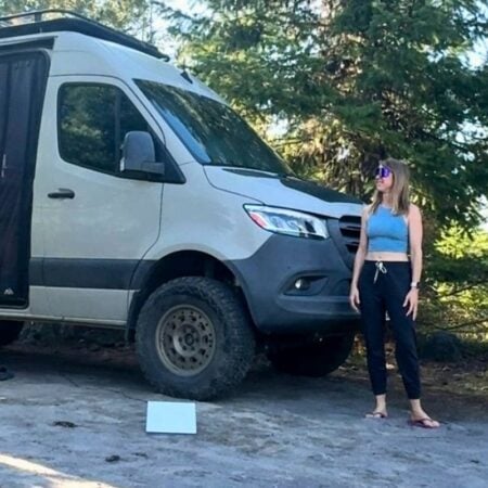 woman standing next to sprinter van
