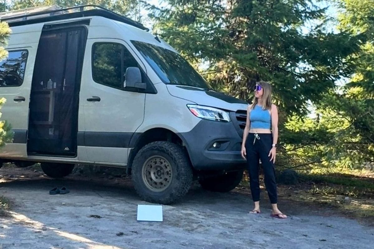 woman standing next to sprinter van
