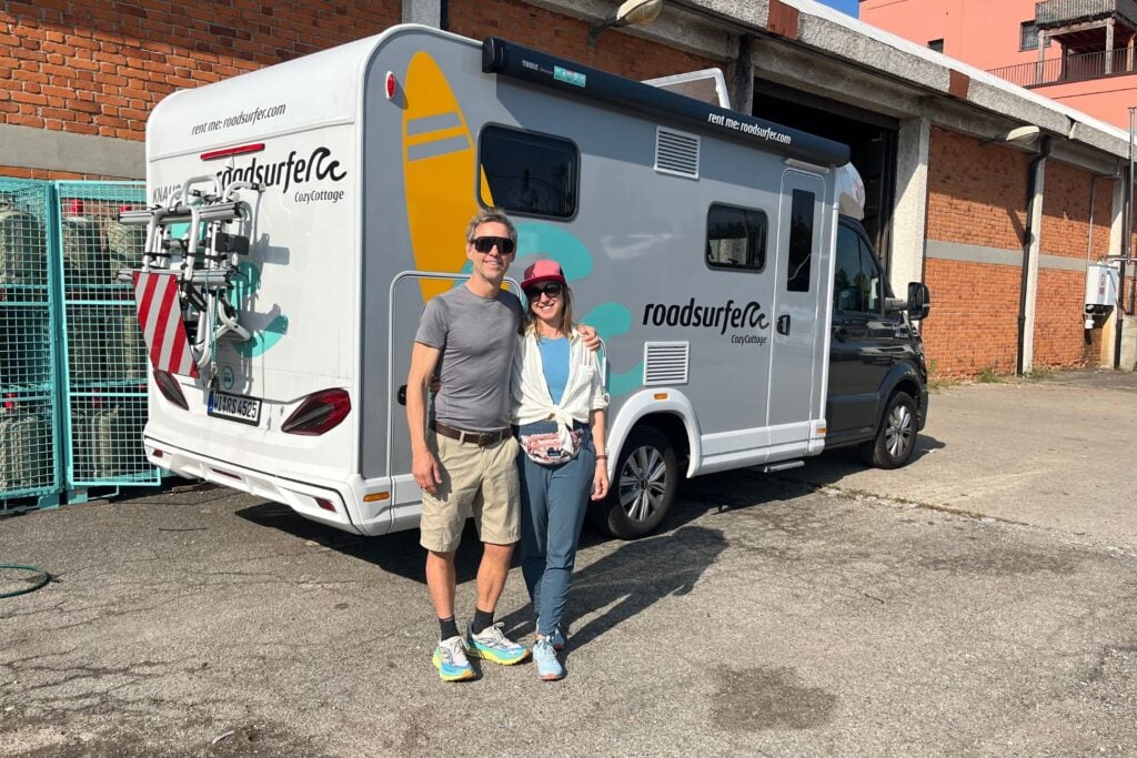 man and woman standing by Roadsurfer camper rental