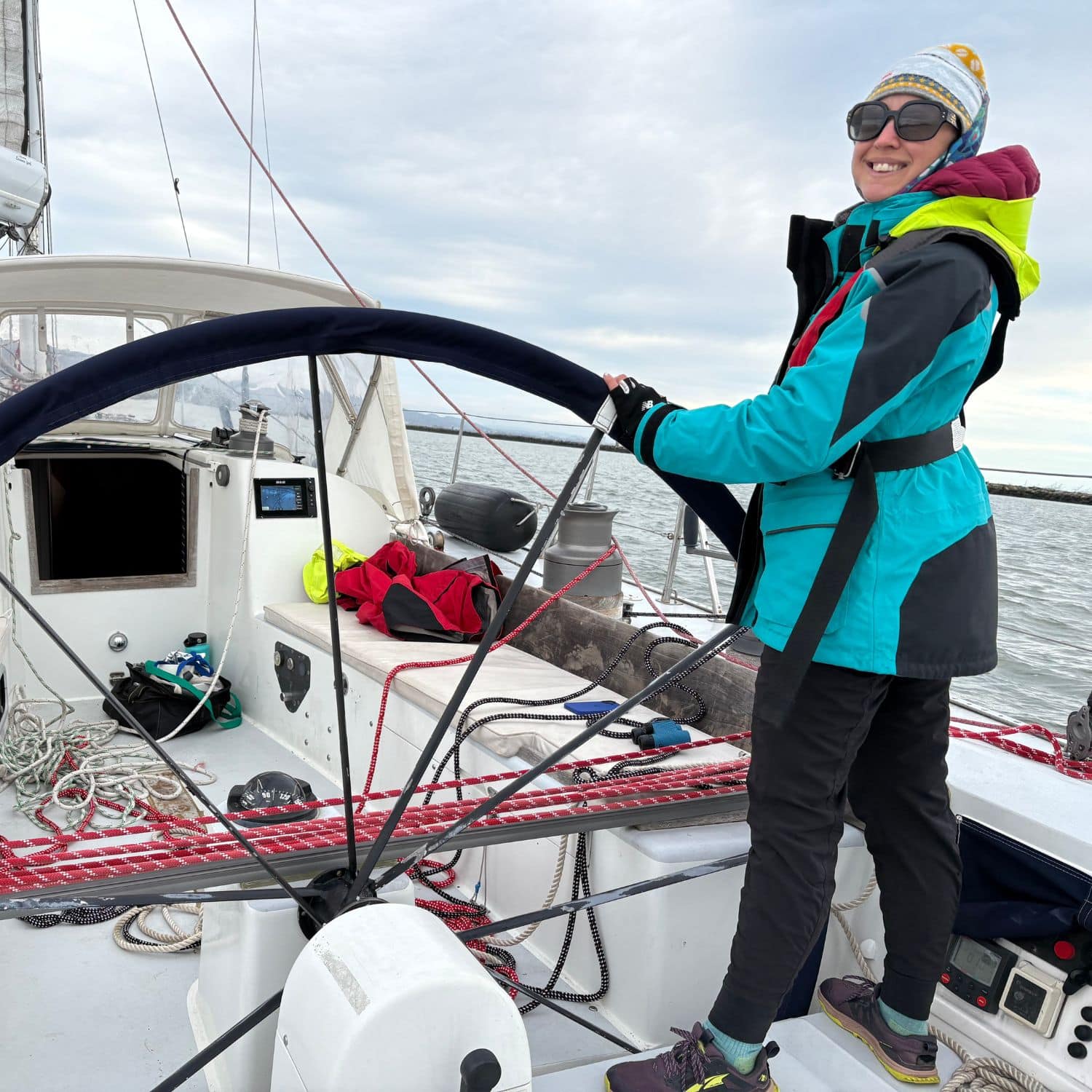 Kristin at the helm of Payah Kun, her Nelson Marek 46, with the black wheel in her hands