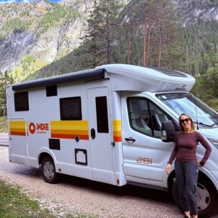 woman standing by indie camper in the dolomites
