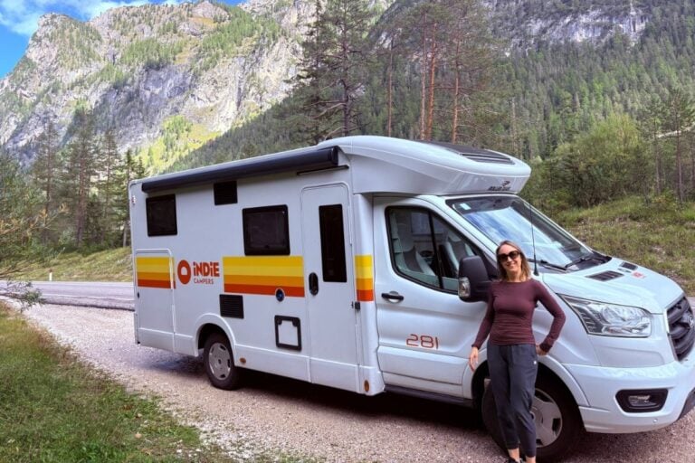 woman standing by indie camper in the dolomites