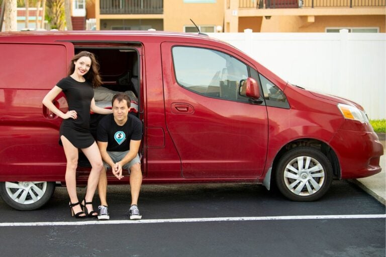couple in front of a red NV200