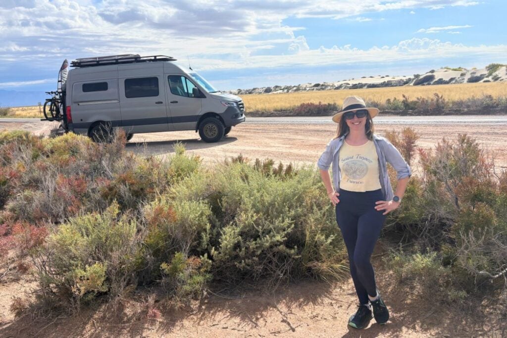 woman standing in front of sprinter van at White Sands National Park