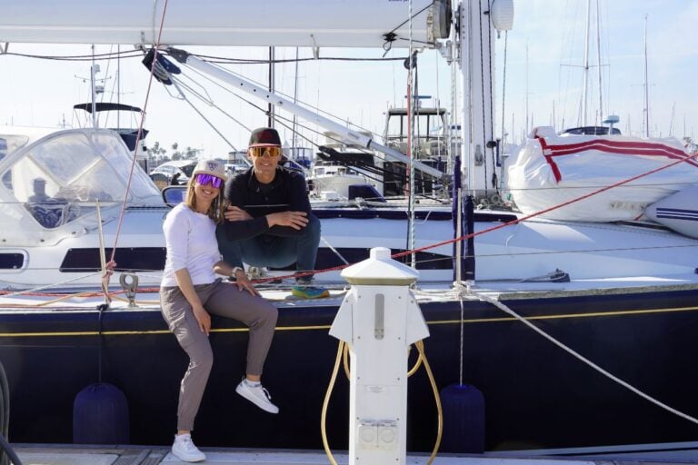 man and woman sitting on sailboat