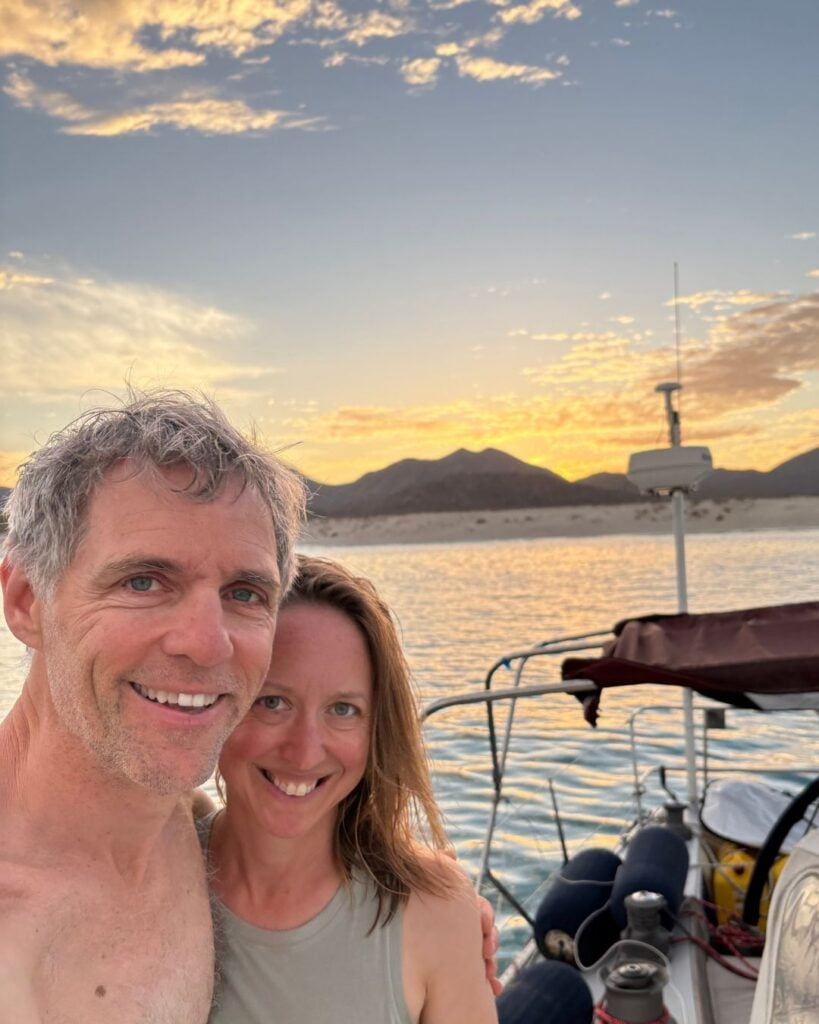 man and woman standing on boat