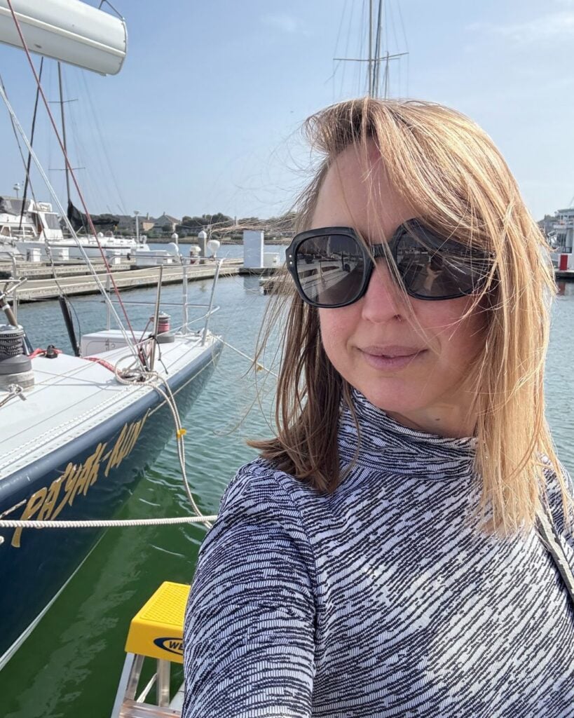 woman standing next to boat in a marina