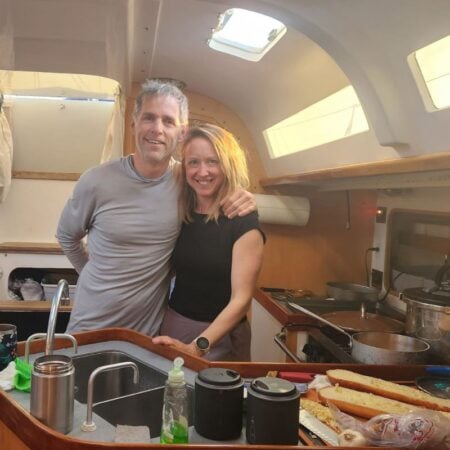 couple standing in sailboat galley