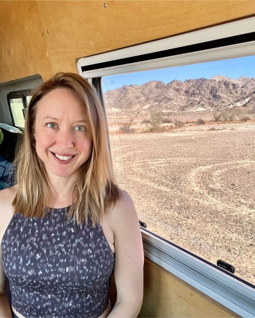 Road trip in tiny home with desert landscape and mountain views, showcasing minimalist living.