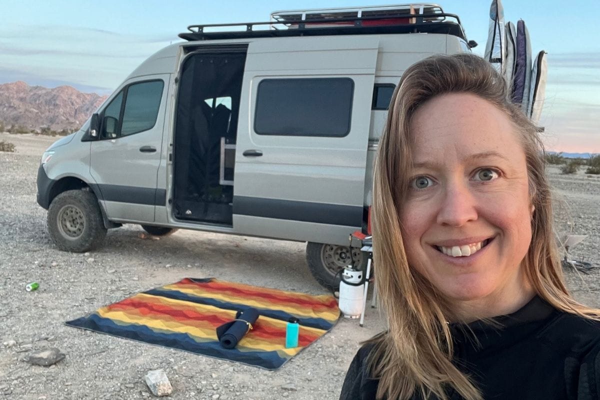 woman standing in front of sprinter van