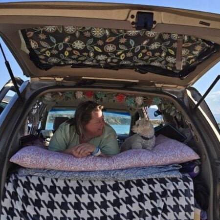 woman and her dog in the back of a minivan