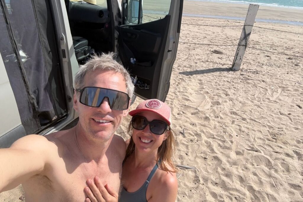 man and woman outside campervan