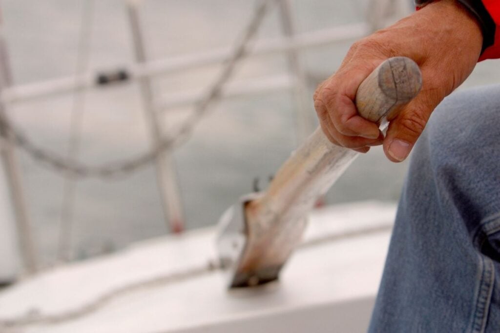 man holding sailboat tiller
