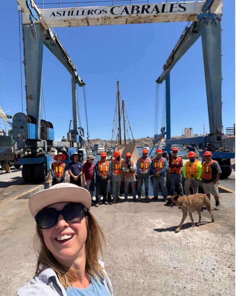 woman standing in front of boatyard crew