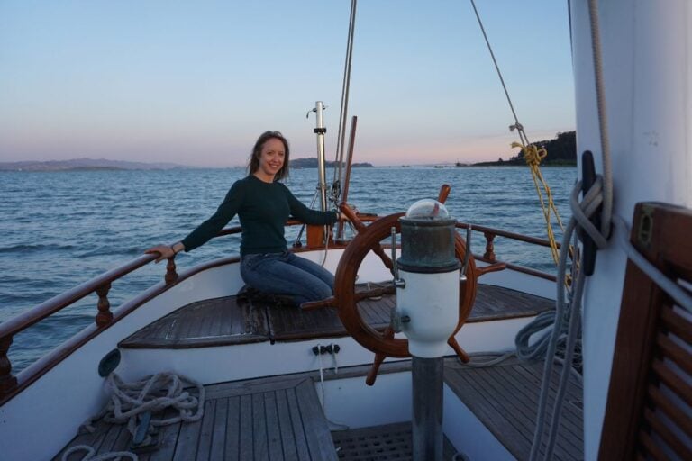 woman sitting on stern of a sailboat