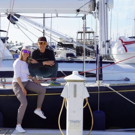 Kristin and Tom aboard their sailboat, the couple behind The Wayward Home