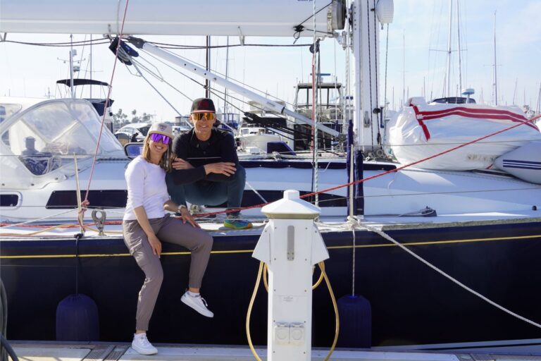 Kristin and Tom aboard their sailboat, the couple behind The Wayward Home