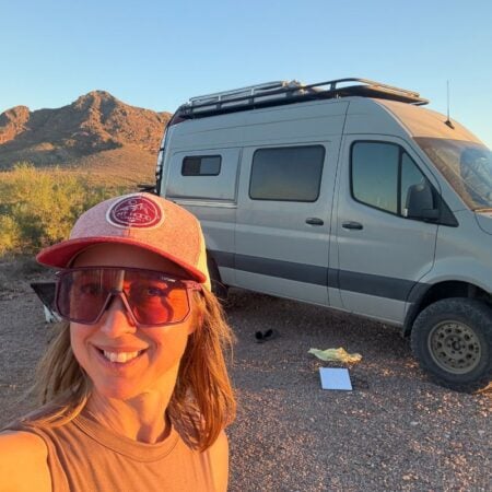 Kristin in front of campervan in the desert