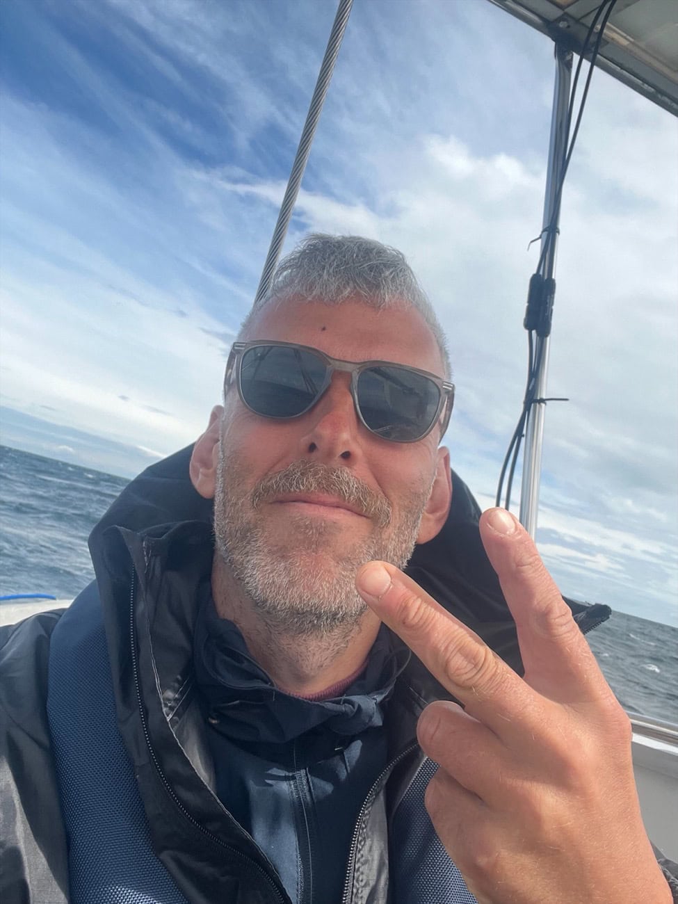 Fredrik, the founder of SailorLove, in sunglasses on his sailboat