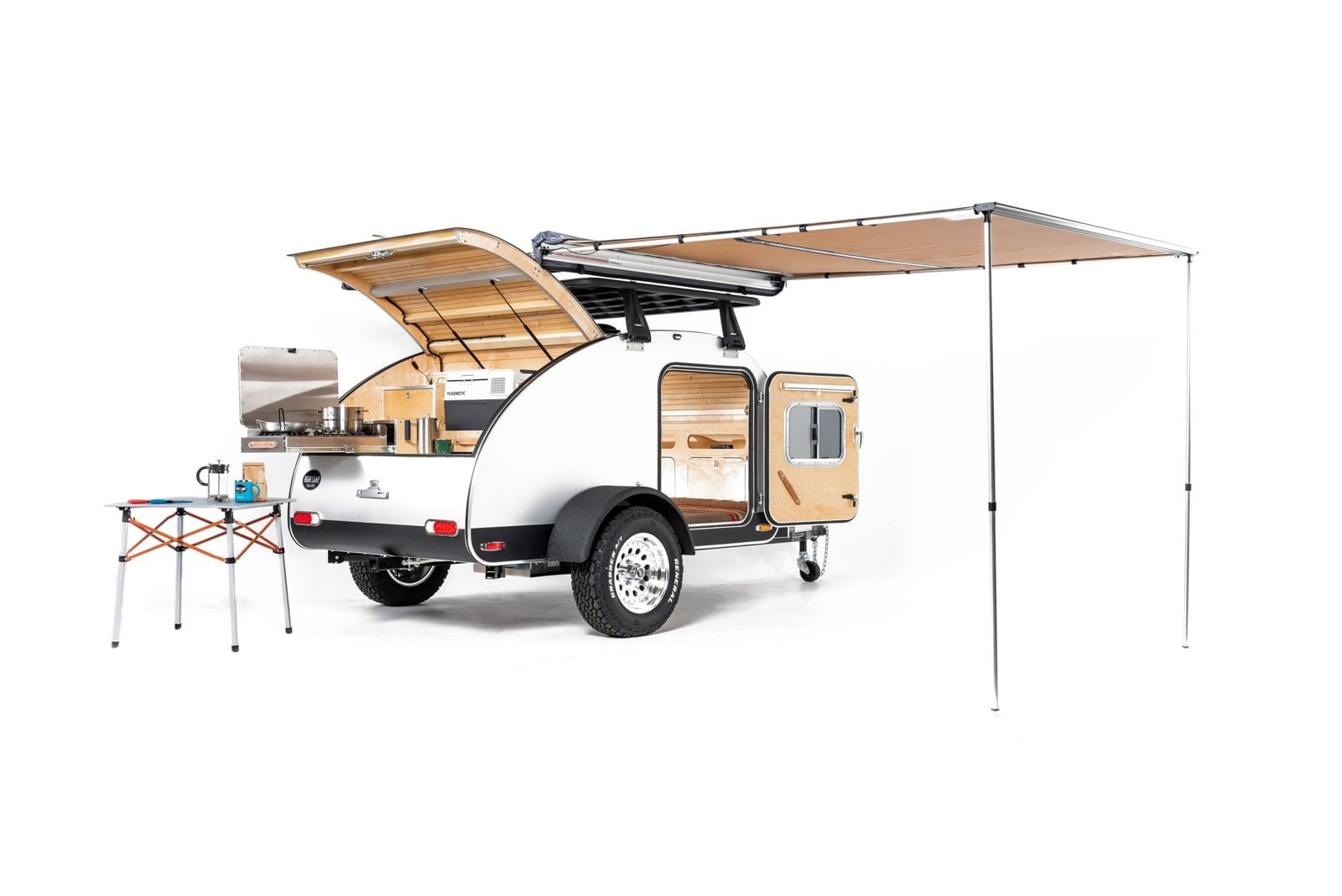 High Camp teardrop trailer with its awning out and camp chairs